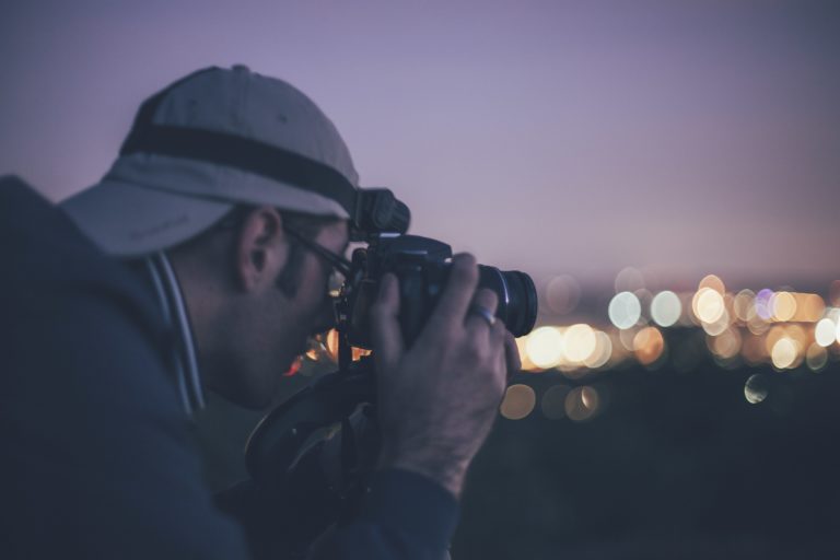 man taking photograph at night