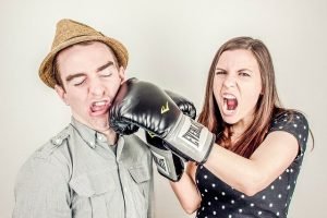 playful fighting, woman hitting man with boxing glove