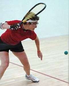 woman hitting racquetball