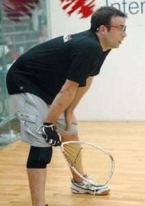 racquetball player, racquet in hand, goggles on