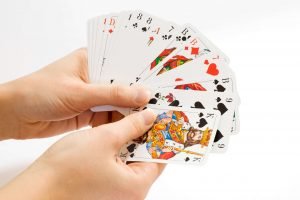 hands holding an open deck of cards