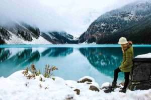 woman hiking, lake, snow, relaxing