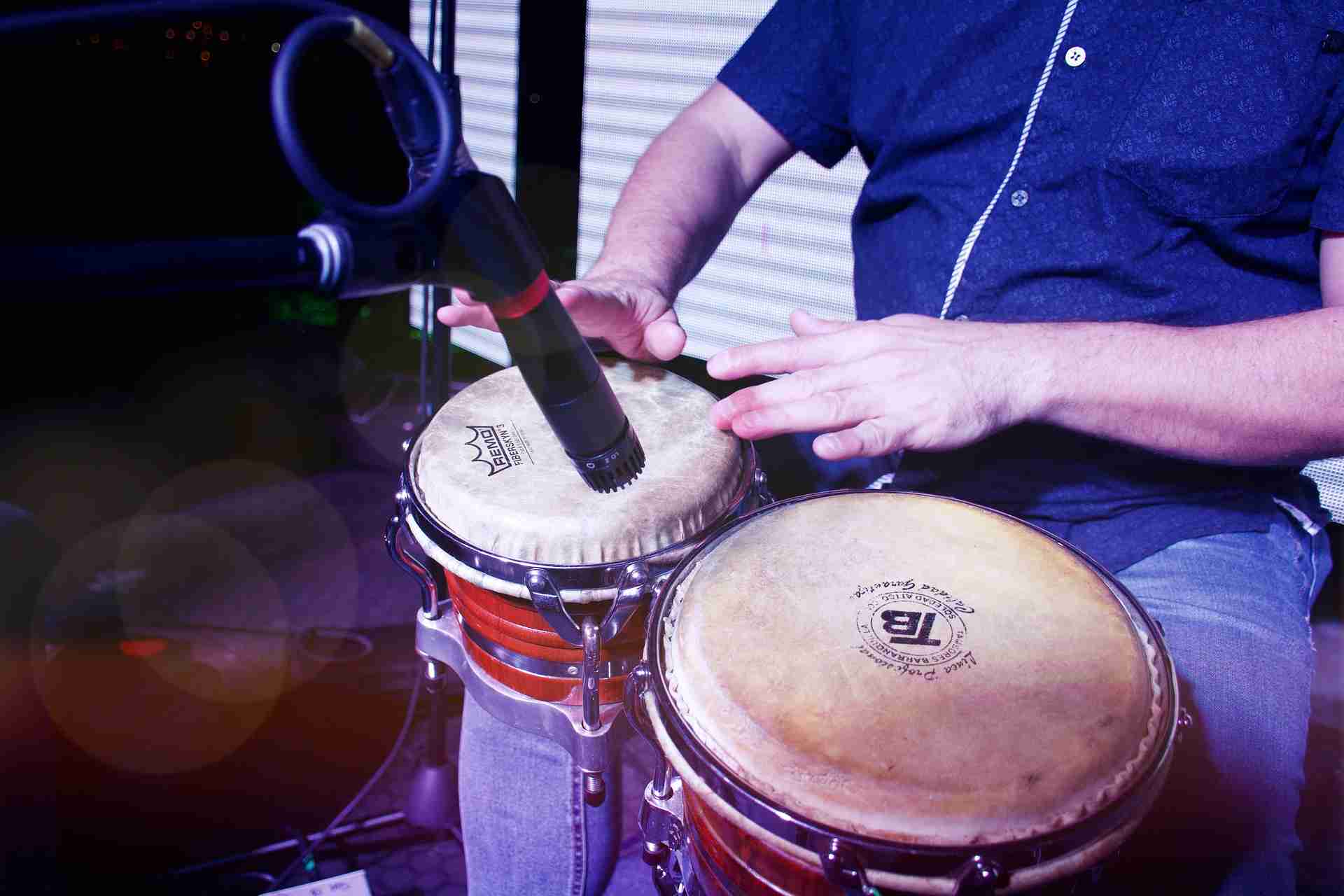 man playing bongos, microphone