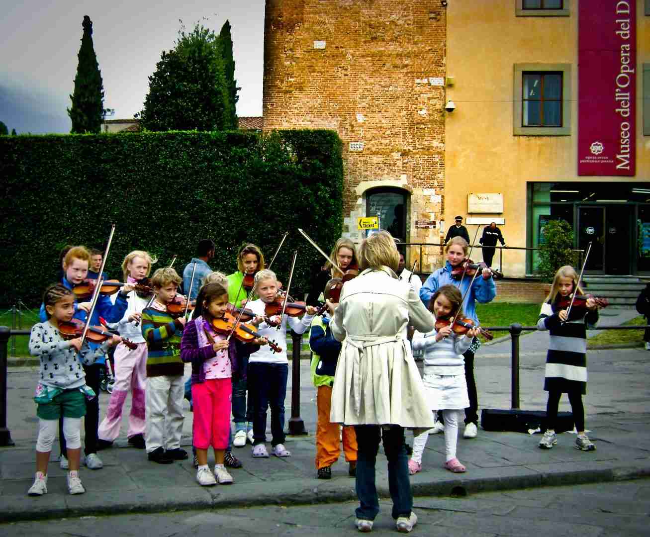 music teacher in front of children playing music