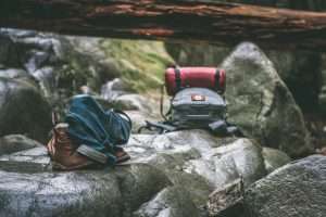 2 backpacks. on rocks. log. hiking. orienteering