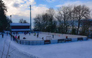 people ice skating, playing hockey