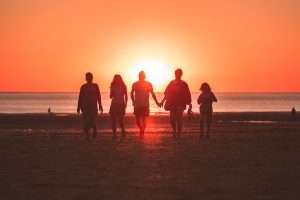 Mental Health Benefits of Team Sports, mental health, people walking on beach during sunset