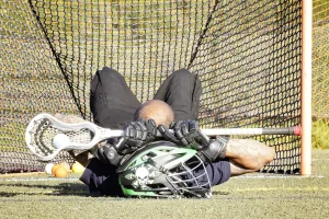 lacrosse, man laying down with lacross stick, list of team sports