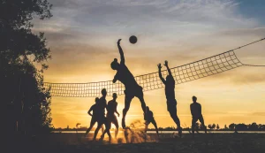 volleyball being played at dusk, beach volleyball being played