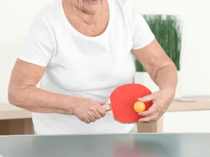old woman playing ping pong