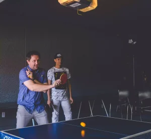 man hitting ping pong ball
