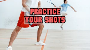 two men hitting squash ball
