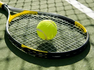 tennis-ball-on-racket-and-ground